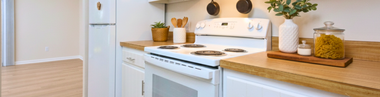 Well lit kitchen with decor leading into dining room