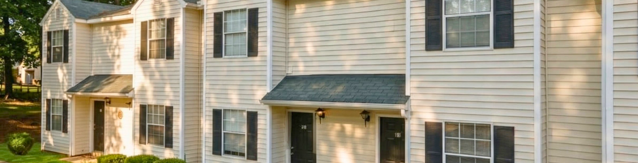 White building with black shutters at sunset